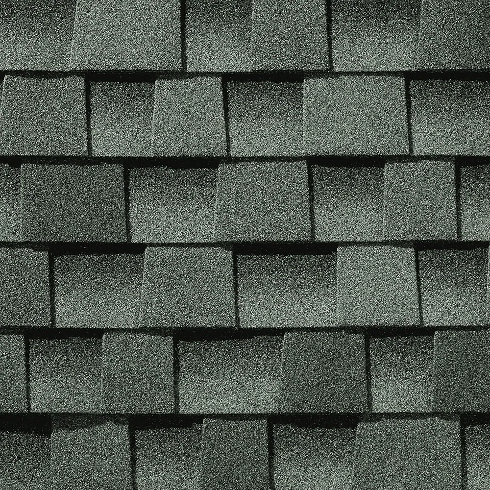 A close-up, repeating pattern of dark gray asphalt shingles, showing the granular texture and layered appearance.